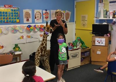 a nurse from Pediatric Dentistry talks with children at EduCare